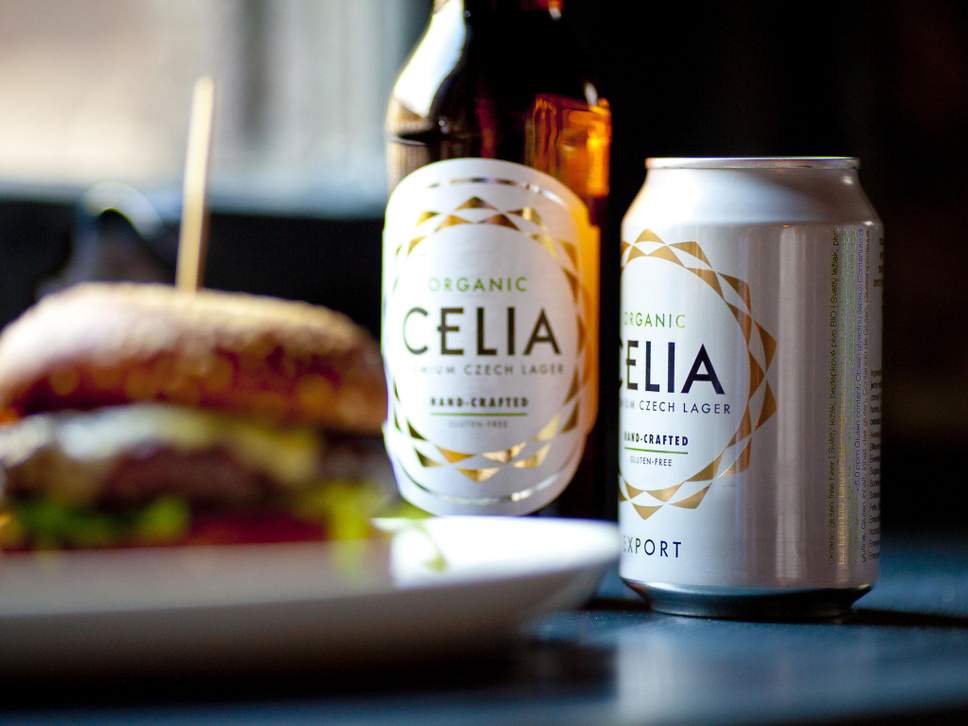 A can and a bottle of CELIA behind a gourmet burger